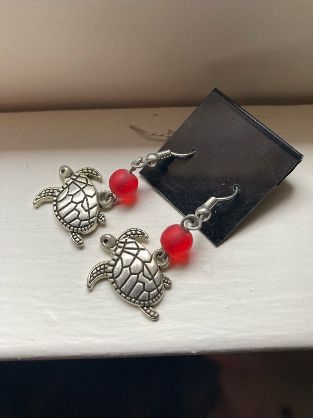 Earrings: NWT: Turtle silver TONED with red bead